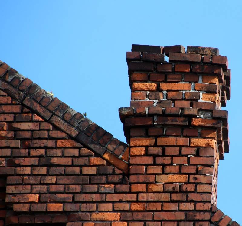 Damaged chimney on an Miami Gardens home showing cracks and missing mortar